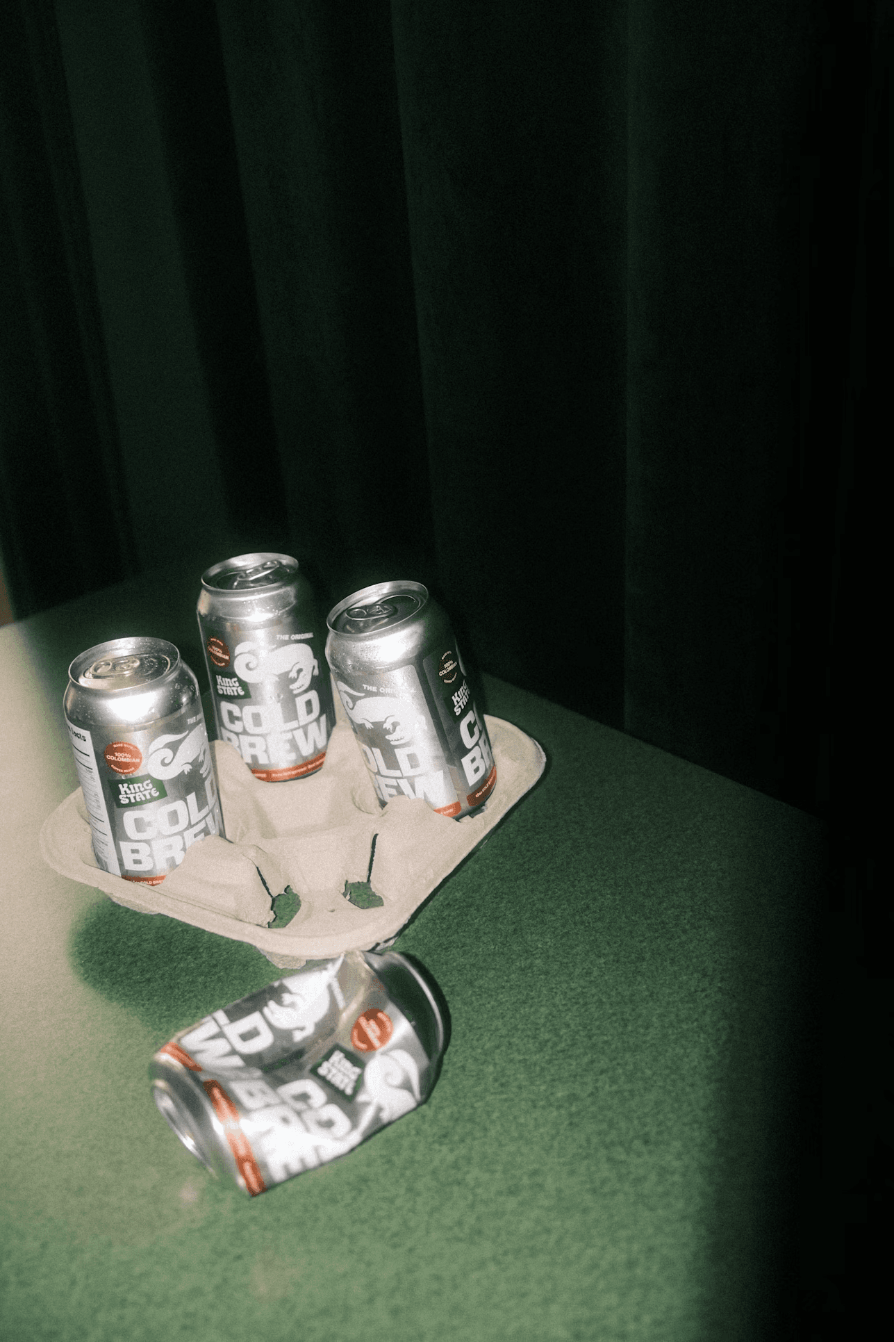 Cold brew cans on green table